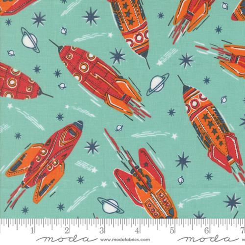 A closeup shot of the quilting fabric pattern called Vintage Rockets, designed by Stacy Iest Hsu, in the blue nebula colorway. The SKU is 20950 17.