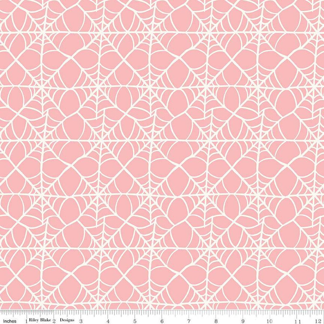 A closeup shot of the quilting fabric pattern called Webs, designed by My Mind's Eye for Riley Blake, in the pink colorway. The SKU is C16033-PINK.