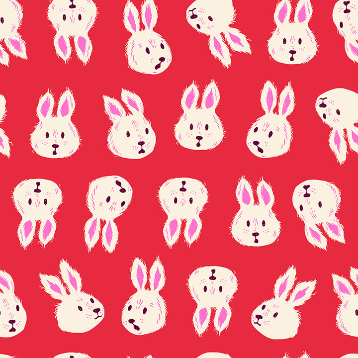 A closeup shot of the quilting fabric pattern called Rushing Rabbit, designed by Sarah Watts for Ruby Star Society, in the ruby colorway. The SKU is RS2125 13.