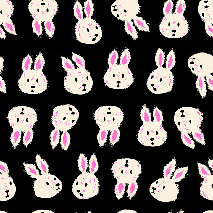 A closeup shot of the quilting fabric pattern called Rushing Rabbit, designed by Sarah Watts for Ruby Star Society, in the black colorway. The SKU is RS2125 14.