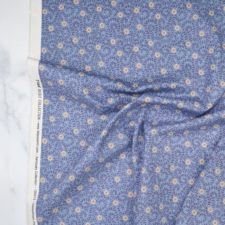 Cotton quilting fabric pattern called 'Daisydream Pitch Blue'. Part of the 'Sanctuary' fabric collection. Designed by Tone Finnanger for fabric company Tilda Fabrics. SKU: TIL100573. 44-45 inch width.